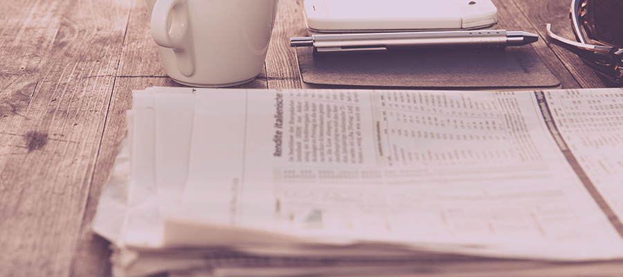 coffee mug next to a piece of paper