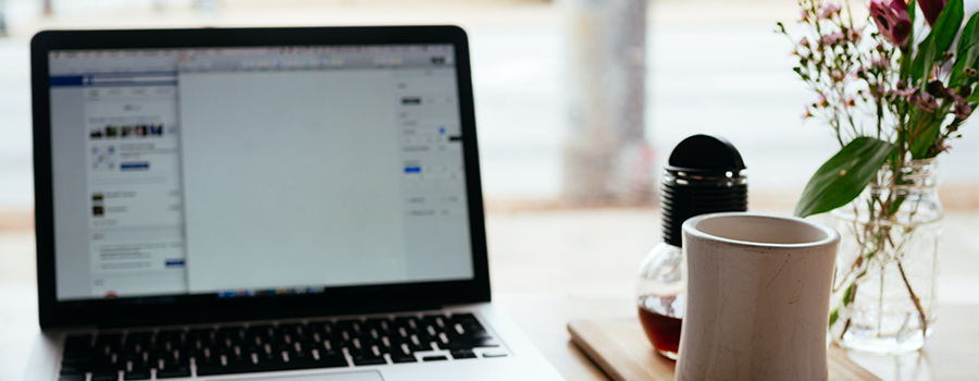 An open notebook in front of a laptop.