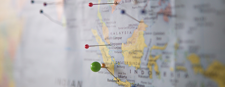 A series of pins on a world map.