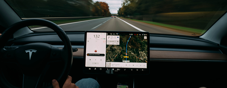 A driver using the navigation system in their vehicle.