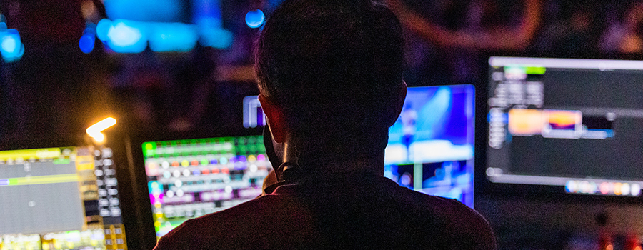 A person monitoring various computer screens.