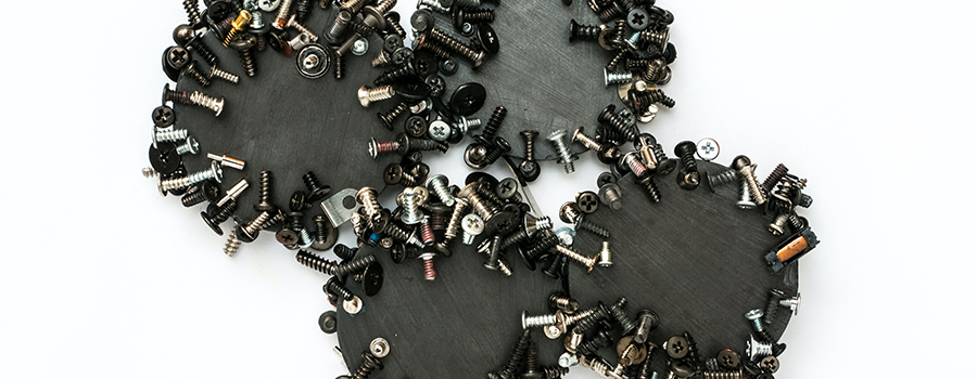 Four magnets with screws sticking to them.